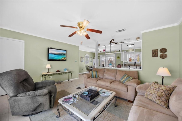 living room featuring crown molding, light tile patterned floors, and ceiling fan