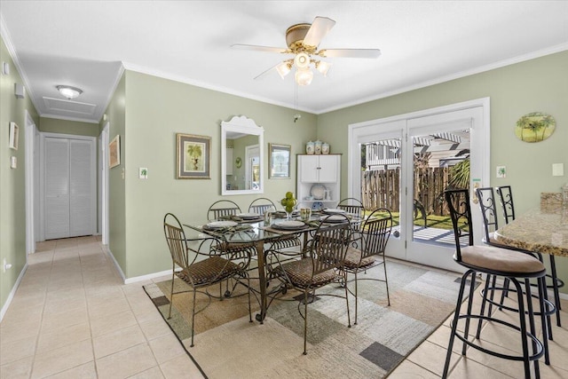 dining room featuring crown molding, ceiling fan, and light tile patterned floors