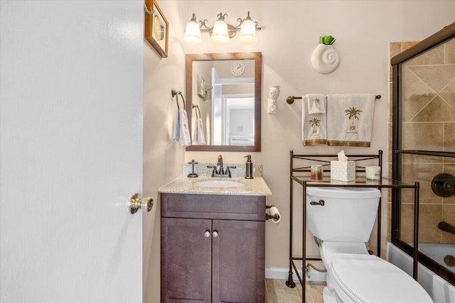 full bathroom featuring vanity, combined bath / shower with glass door, and toilet