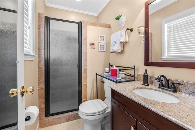 bathroom featuring tile patterned floors, toilet, ornamental molding, vanity, and a shower with door