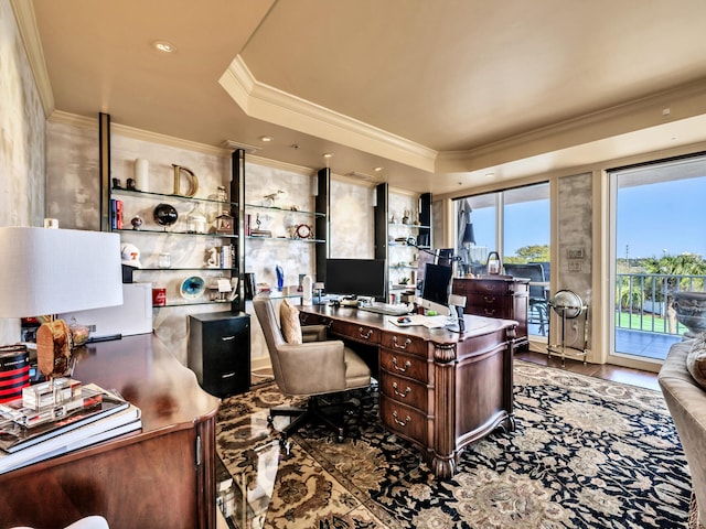 office space with hardwood / wood-style flooring, ornamental molding, and a tray ceiling