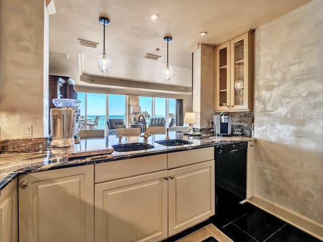 kitchen with sink, decorative light fixtures, dark stone counters, and dishwasher