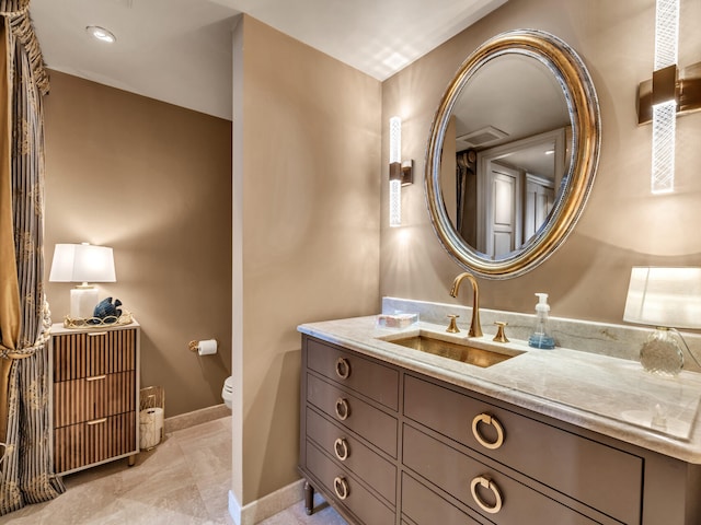 bathroom featuring vanity and toilet