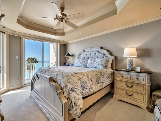 bedroom featuring ornamental molding, a raised ceiling, light carpet, and access to outside