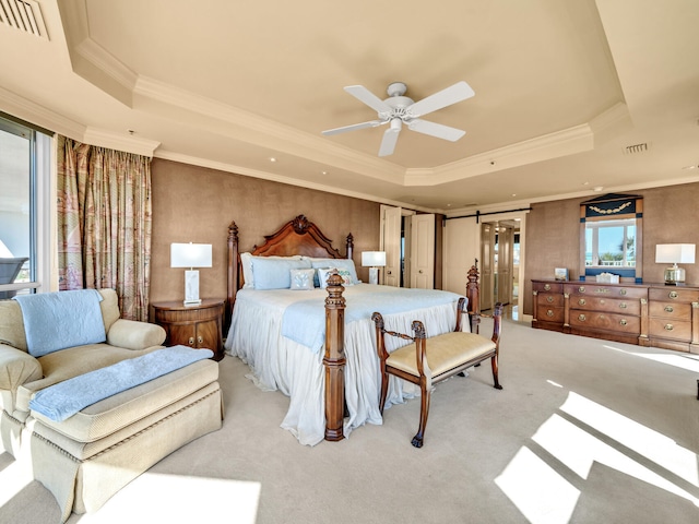 carpeted bedroom with crown molding, ceiling fan, and a raised ceiling