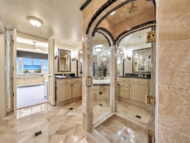 bathroom with ceiling fan, vanity, and a shower with shower door