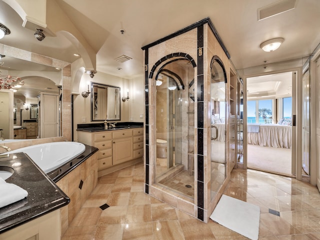 full bathroom featuring vanity, shower with separate bathtub, and toilet