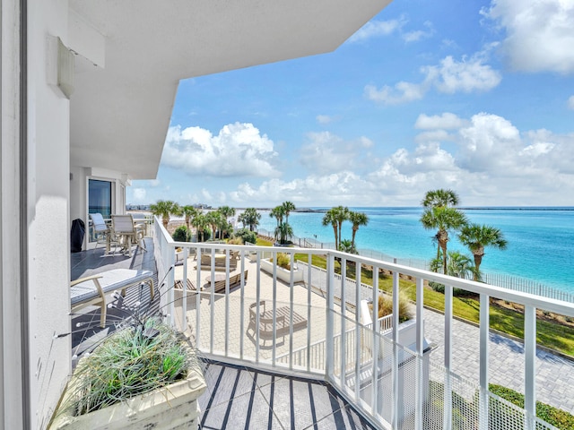 balcony featuring a water view and a beach view