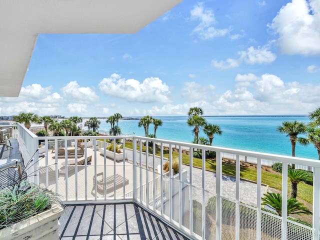 balcony with a water view and a beach view