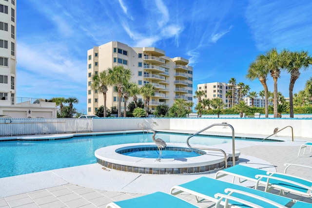 view of swimming pool with a community hot tub and a patio