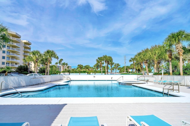 view of pool featuring a hot tub and a patio area