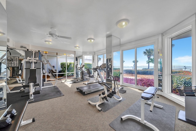 exercise room with ceiling fan