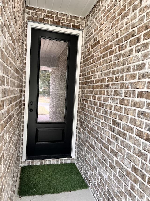 entrance to property with brick siding