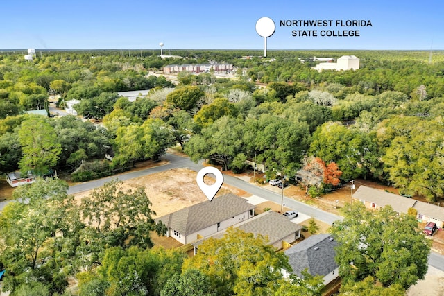 birds eye view of property with a wooded view