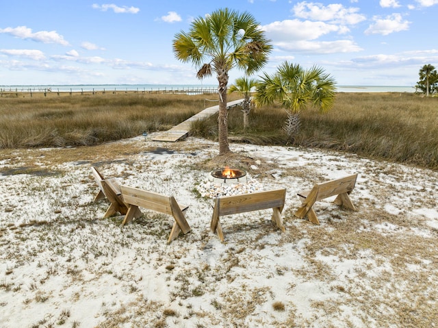 view of yard with a water view and a fire pit