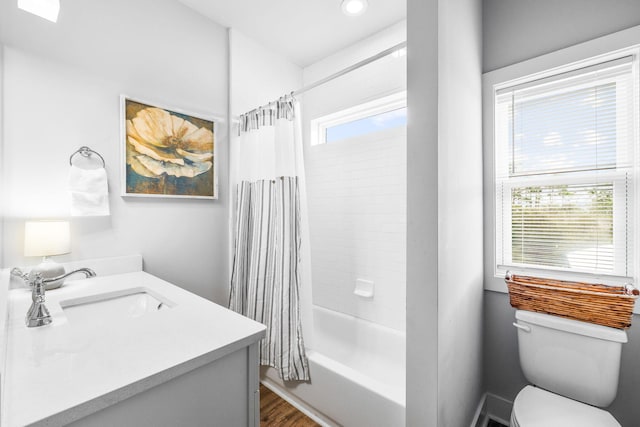 full bathroom featuring a healthy amount of sunlight, toilet, shower / tub combo, and vanity