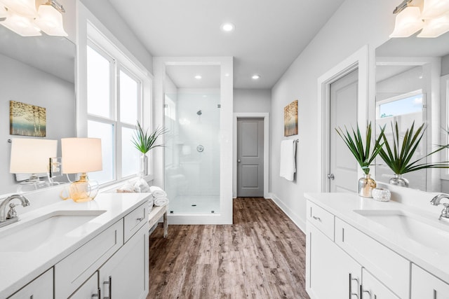 bathroom featuring vanity, hardwood / wood-style flooring, and a shower with shower door