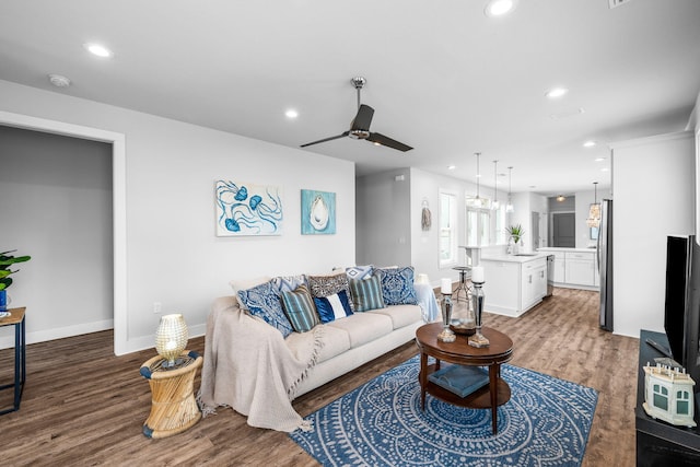 living room featuring hardwood / wood-style flooring and ceiling fan