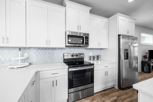 kitchen featuring tasteful backsplash, stainless steel appliances, dark hardwood / wood-style floors, and white cabinets