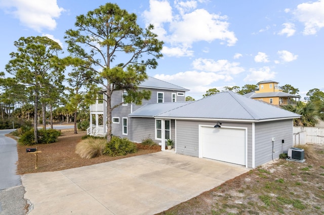 view of front facade featuring a garage and central AC