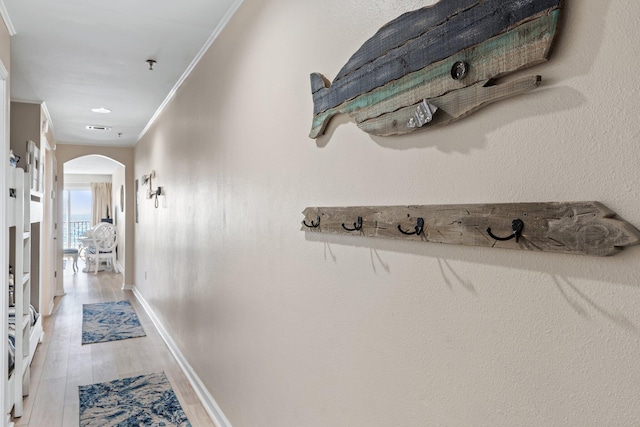 hall featuring crown molding and light wood-type flooring