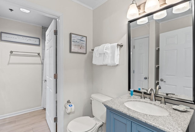 bathroom with vanity, crown molding, toilet, and hardwood / wood-style flooring