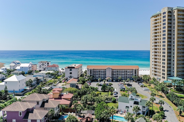 birds eye view of property with a water view and a view of the beach