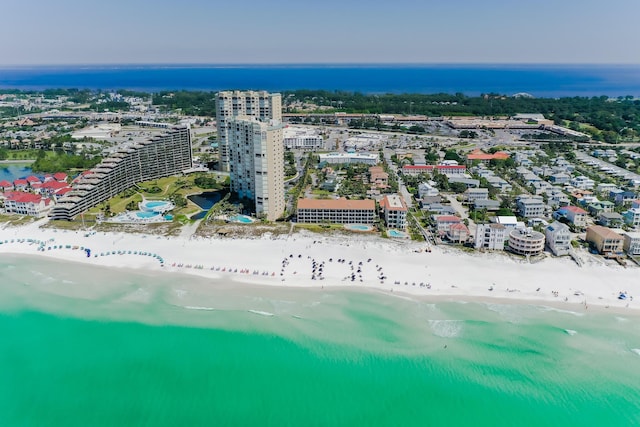 drone / aerial view featuring a beach view and a water view