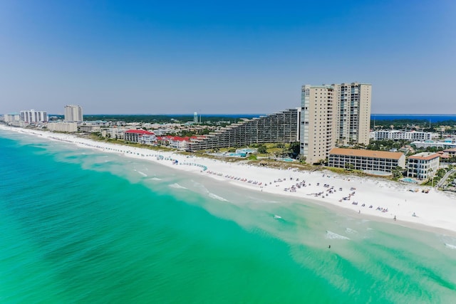 bird's eye view with a water view and a beach view