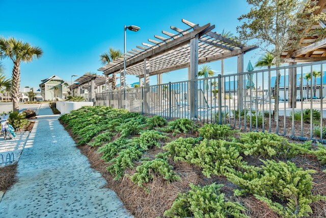 view of community featuring a residential view, fence, and a pergola