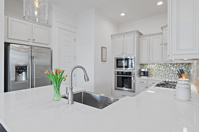 kitchen with decorative backsplash, ornamental molding, light stone countertops, stainless steel appliances, and a sink