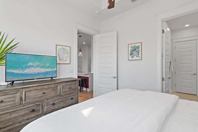 bedroom with light wood finished floors and ceiling fan