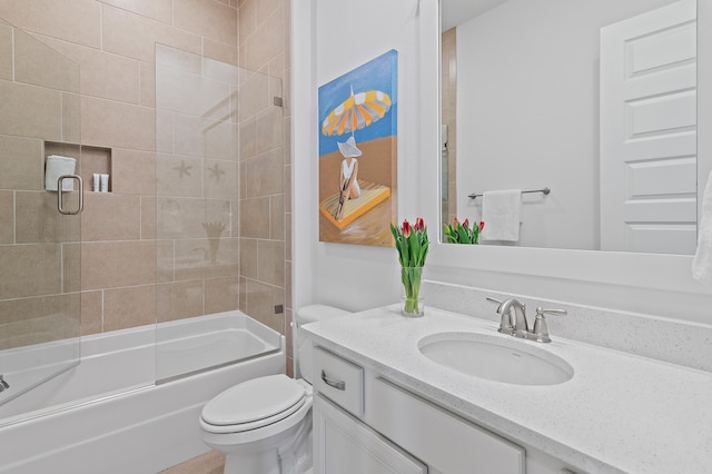 full bath featuring toilet, bath / shower combo with glass door, and vanity