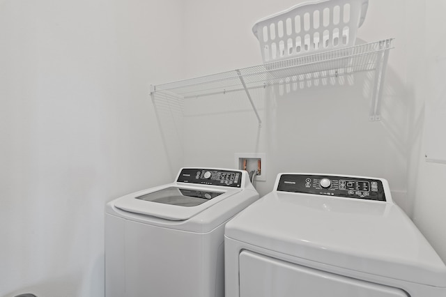 clothes washing area with laundry area and washing machine and clothes dryer