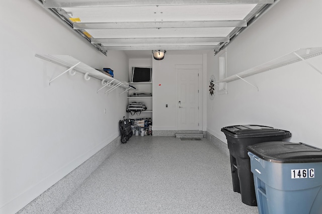 garage featuring baseboards and a garage door opener