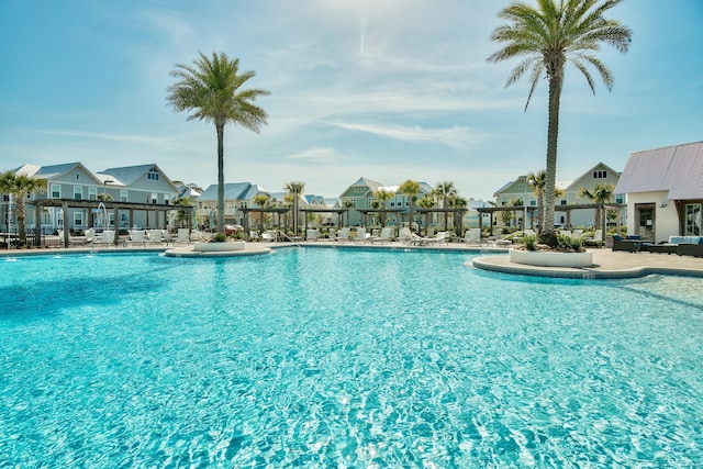 community pool featuring a residential view and a patio