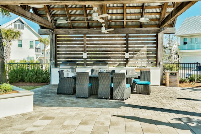 view of patio with an outdoor kitchen, fence, a ceiling fan, and a grill