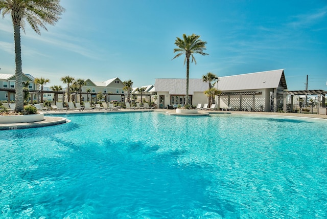 community pool with a patio area and a residential view