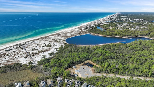 birds eye view of property with a water view and a view of the beach