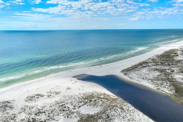 drone / aerial view featuring a beach view and a water view