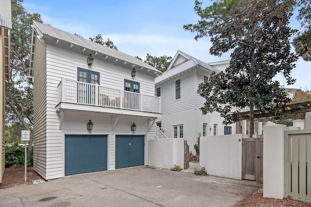 view of front facade featuring a balcony and a garage