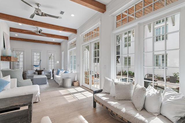 sunroom featuring ceiling fan, french doors, and beamed ceiling