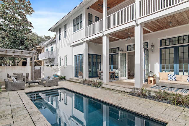 view of swimming pool featuring an outdoor living space, a patio, ceiling fan, and a pergola