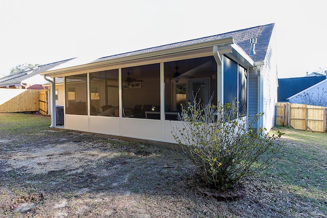 back of property featuring ceiling fan and a sunroom