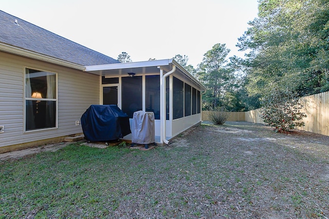 exterior space featuring a lawn and a sunroom