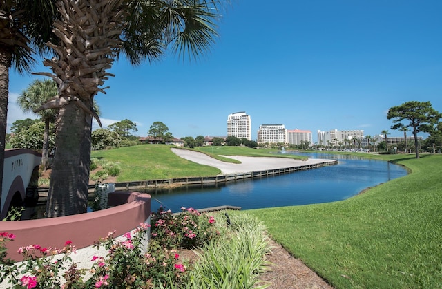 view of home's community with a yard and a water view