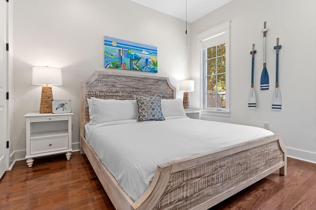 bedroom with dark hardwood / wood-style floors