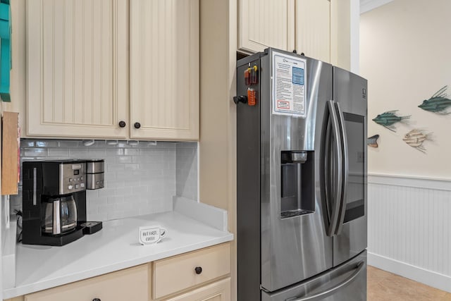 kitchen with stainless steel fridge with ice dispenser, decorative backsplash, and light tile patterned floors