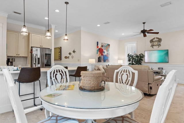 dining room with light tile patterned floors, crown molding, and ceiling fan