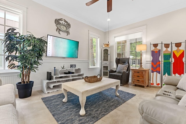 living room with ornamental molding, light tile patterned flooring, and ceiling fan